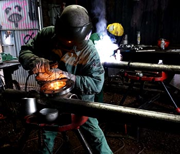 image of worker in steel mill